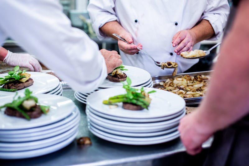 Restaurant manager overseeing service at Pizzana